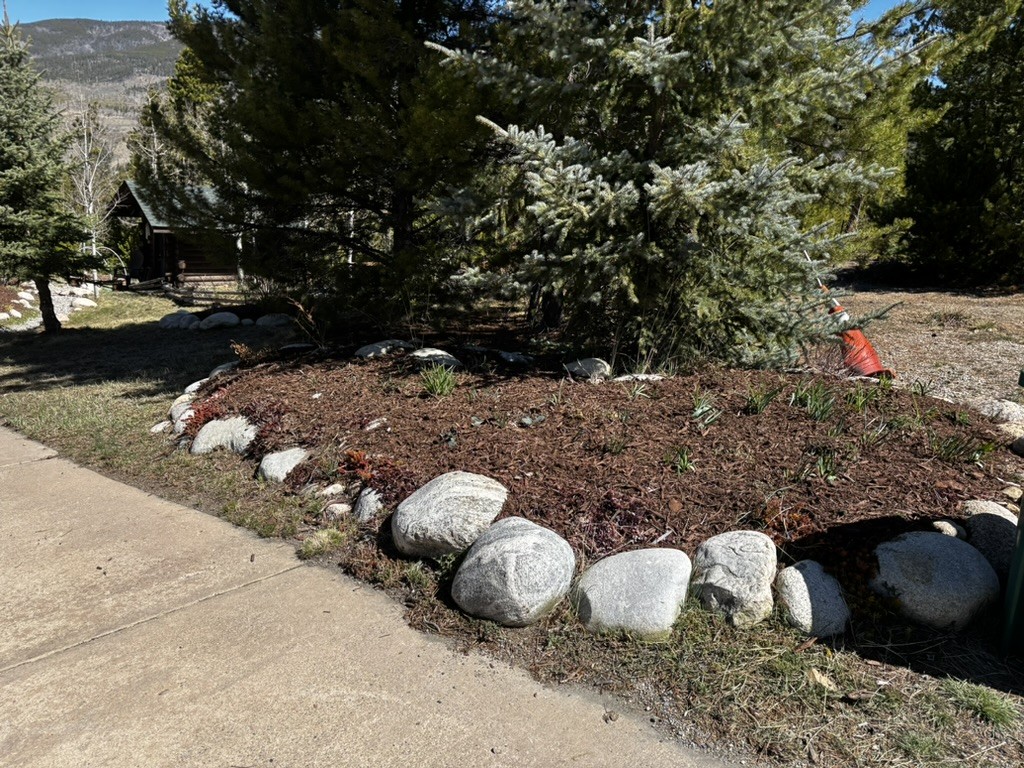 Hardscape rock border and mulch bed in Colorado